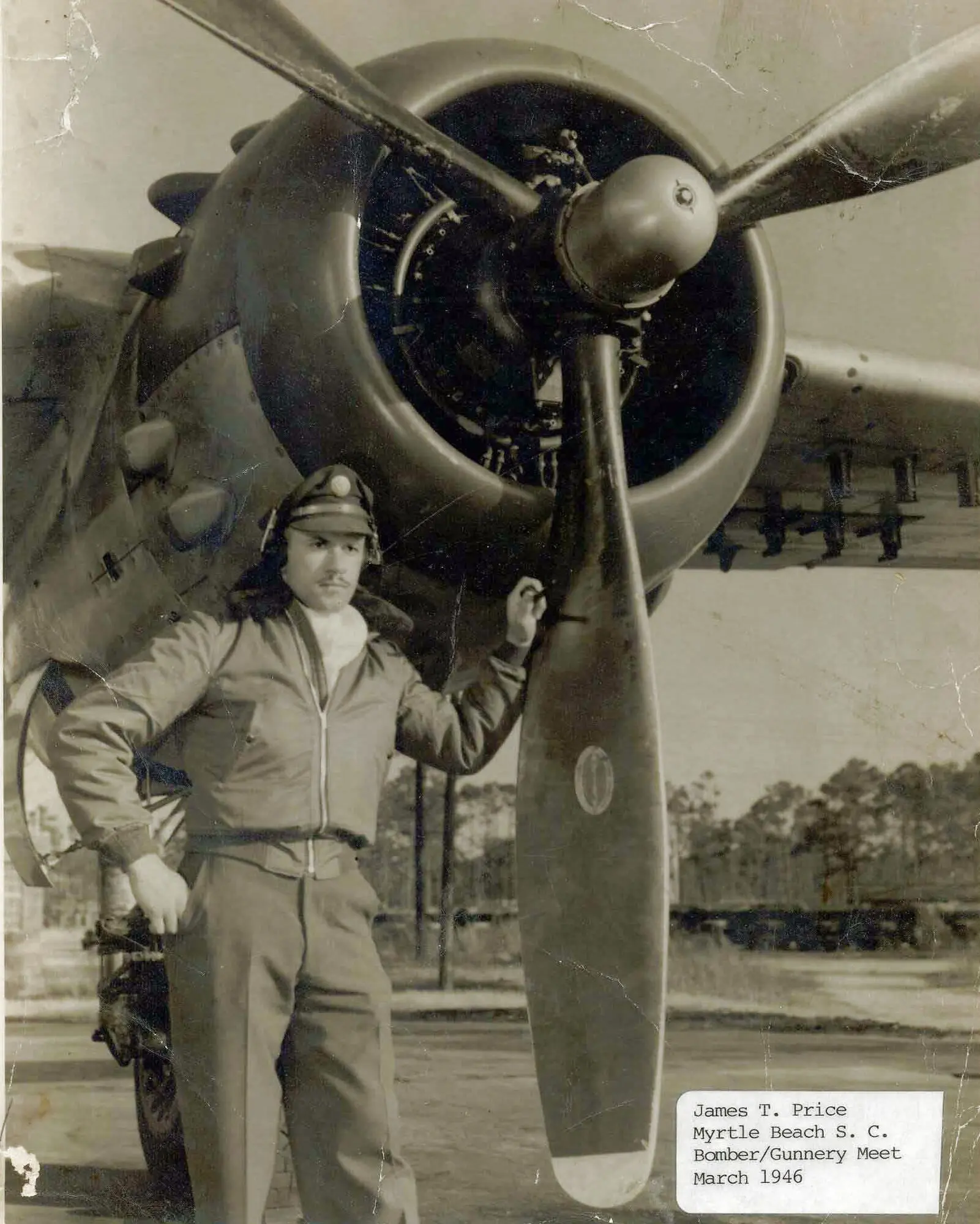 James T. Price, then a Tuskegee Airman, poses in front of a B-25 in 1946 at Myrtle Beach, N.C.
