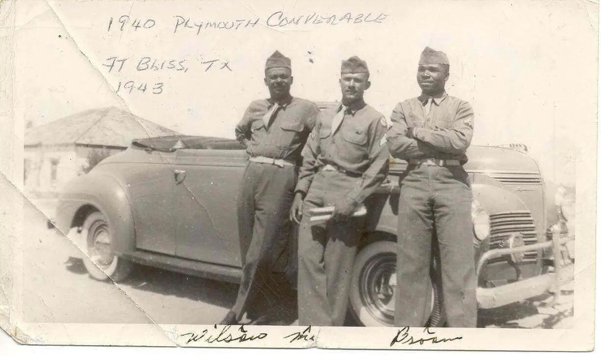 James T. Price, then a Tuskegee Airman, poses in front of a 1940 Plymouth Convertible in 1943 at Fort Bliss TX